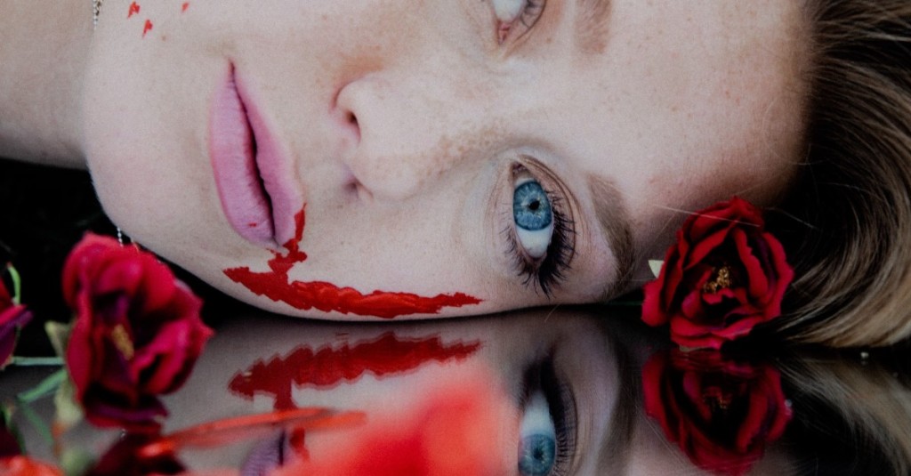 The close up of a dead woman's bloody face lying face down