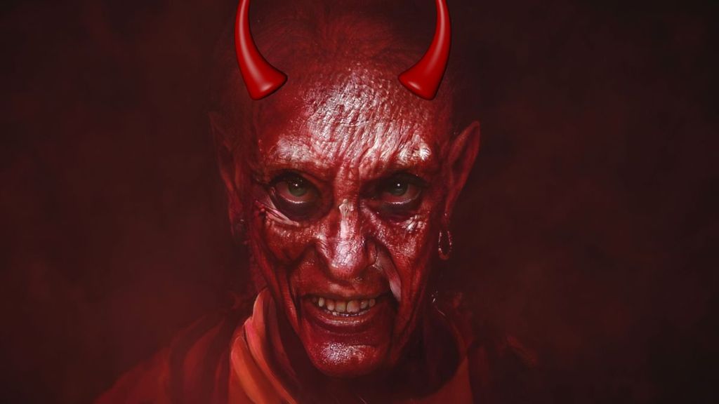 A red faced evil looking devil with red horns on its head