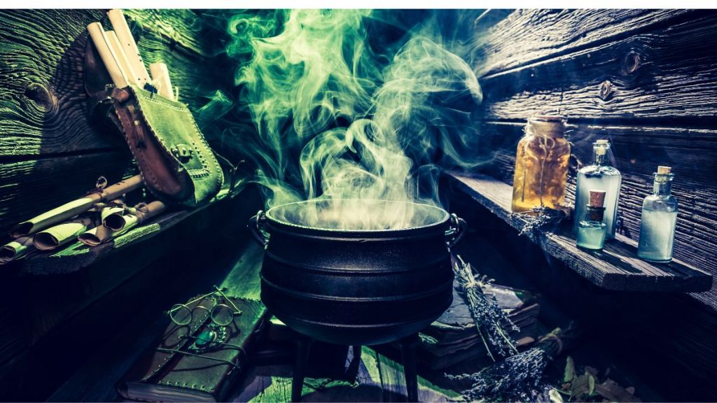 A large black pot with smoke lifting from it and potions and scrolls surrounding it
