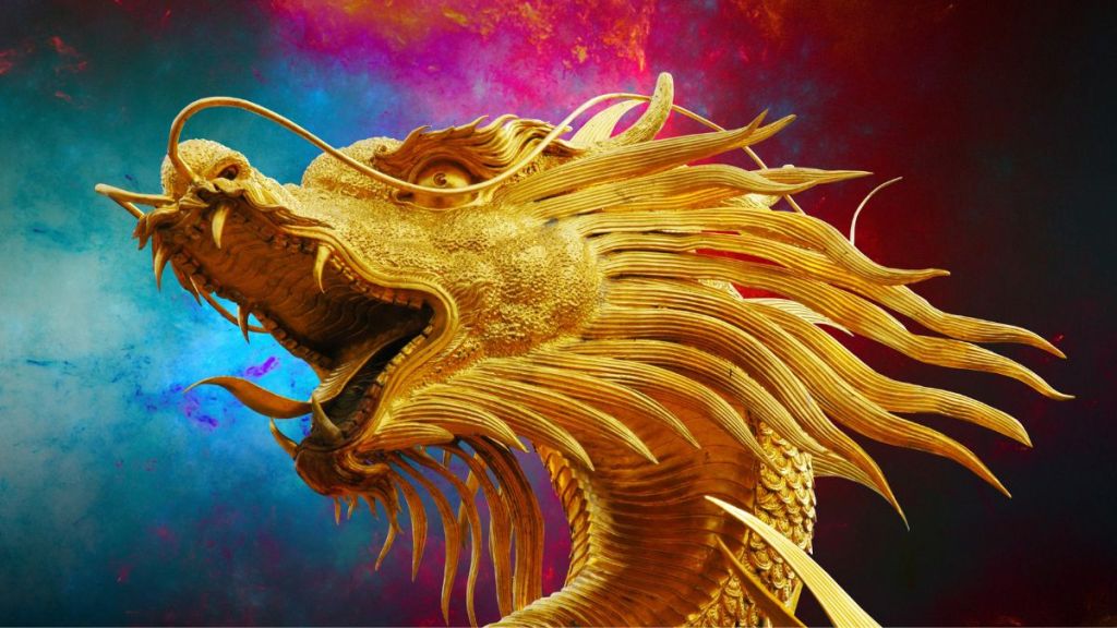 The close up of a golden dragon's head with its tongue out against a multicolored background